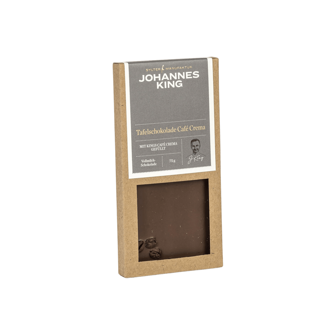 Eine Packung Sylter Manufaktur Kings Café Crema Tafelschokolade, eine Schokolade mit Kaffee, mit einem sichtbaren Teil der Tafel Schokolade durch.
