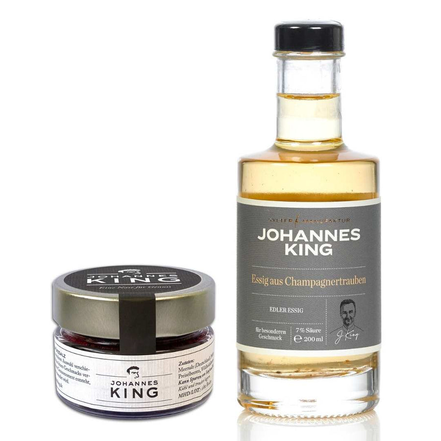 Eine Flasche Essig der Marke Sylter Manufaktur Johannes King Kleines Geschenk für Hobbyköche und ein Einmachglas, beide beschriftet und versiegelt mit Sylter Salz, vor weißem Hintergrund.