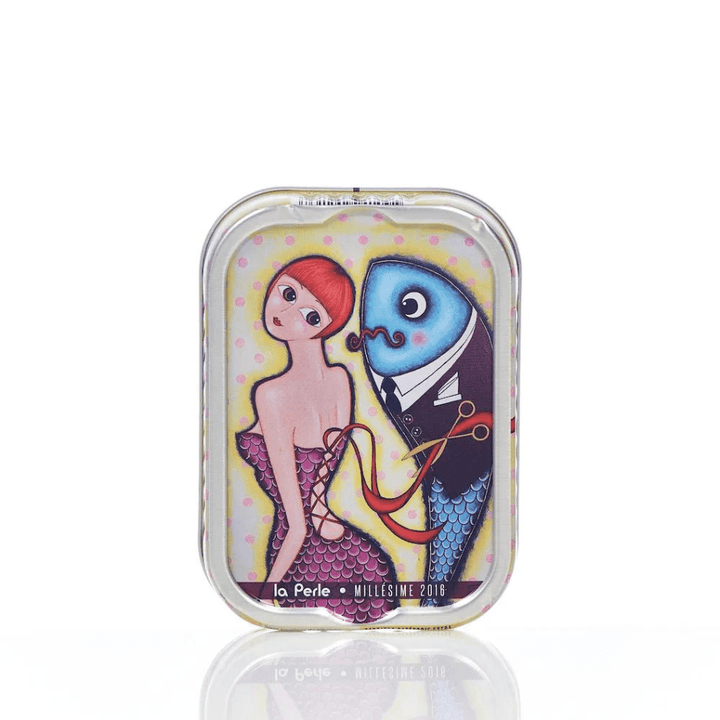 Eine farbenfrohe Illustration auf einer Jahrgangssardinen-Dose, die eine Meerjungfrau und einen Fisch im Anzug zeigt, mit dem Text „La Perle – Jahrgangssardinen 2016 in Olivenöl (Lulu)“
